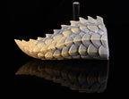 Detailed view of the thorny dorsal spines on dimvra-figurine scaled dragon tail.