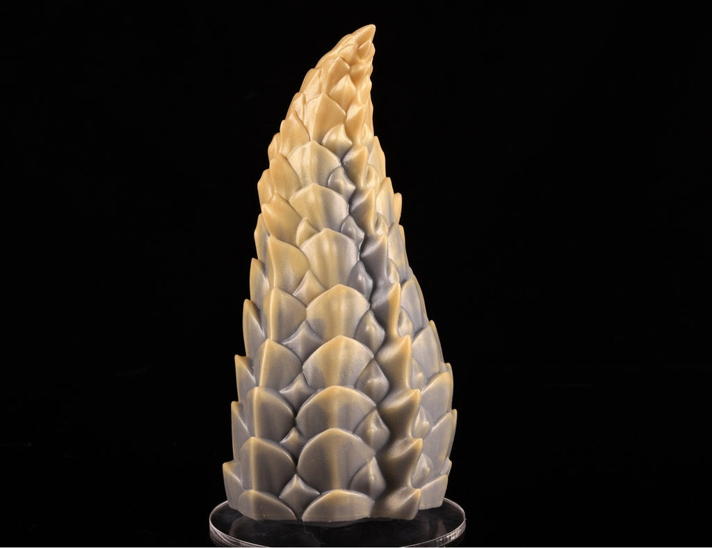 Angle view of the handcrafted platinum silicone dragon tail on its transparent acrylic stand.