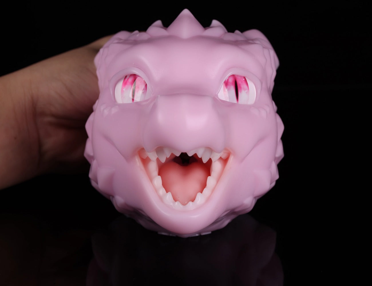 Front view of dimvra-figurine pastel pink dragon head bust showing realistic tongue and teeth details.