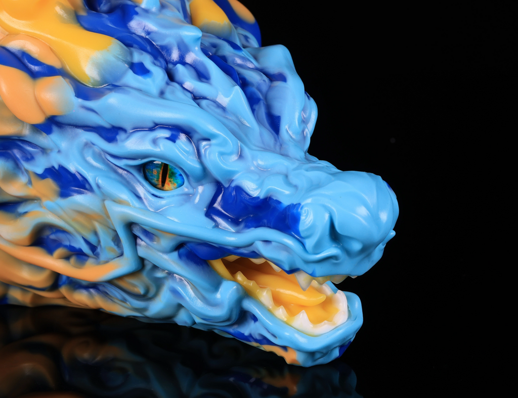 Close-up of realistic eye and vibrant blue and yellow cloud-like mane on dimvra-figurine Oriental dragon figuirne.