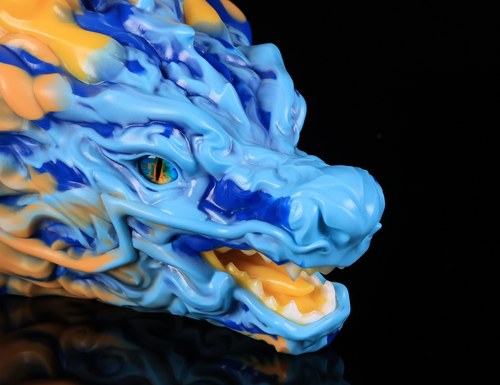 Close-up of realistic eye and vibrant blue and yellow cloud-like mane on dimvra-figurine Oriental dragon figuirne.