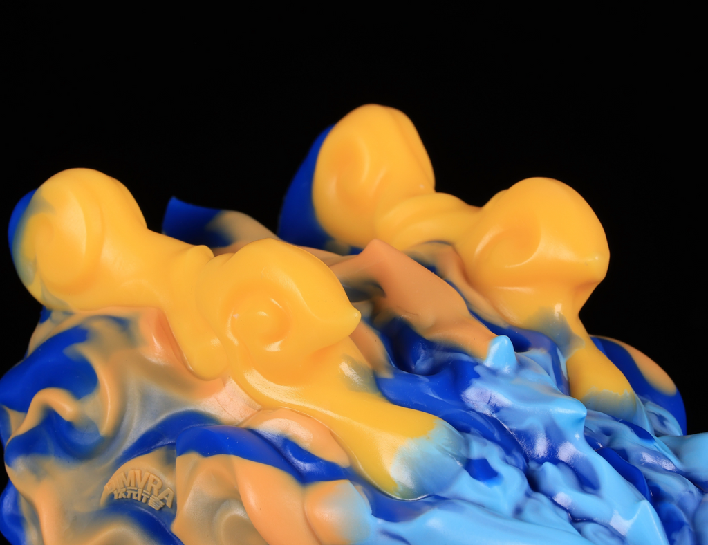 Macro view of the flowing cloud texture on dimvra-figurine Chinese dragon bust in Dunhuang colors.