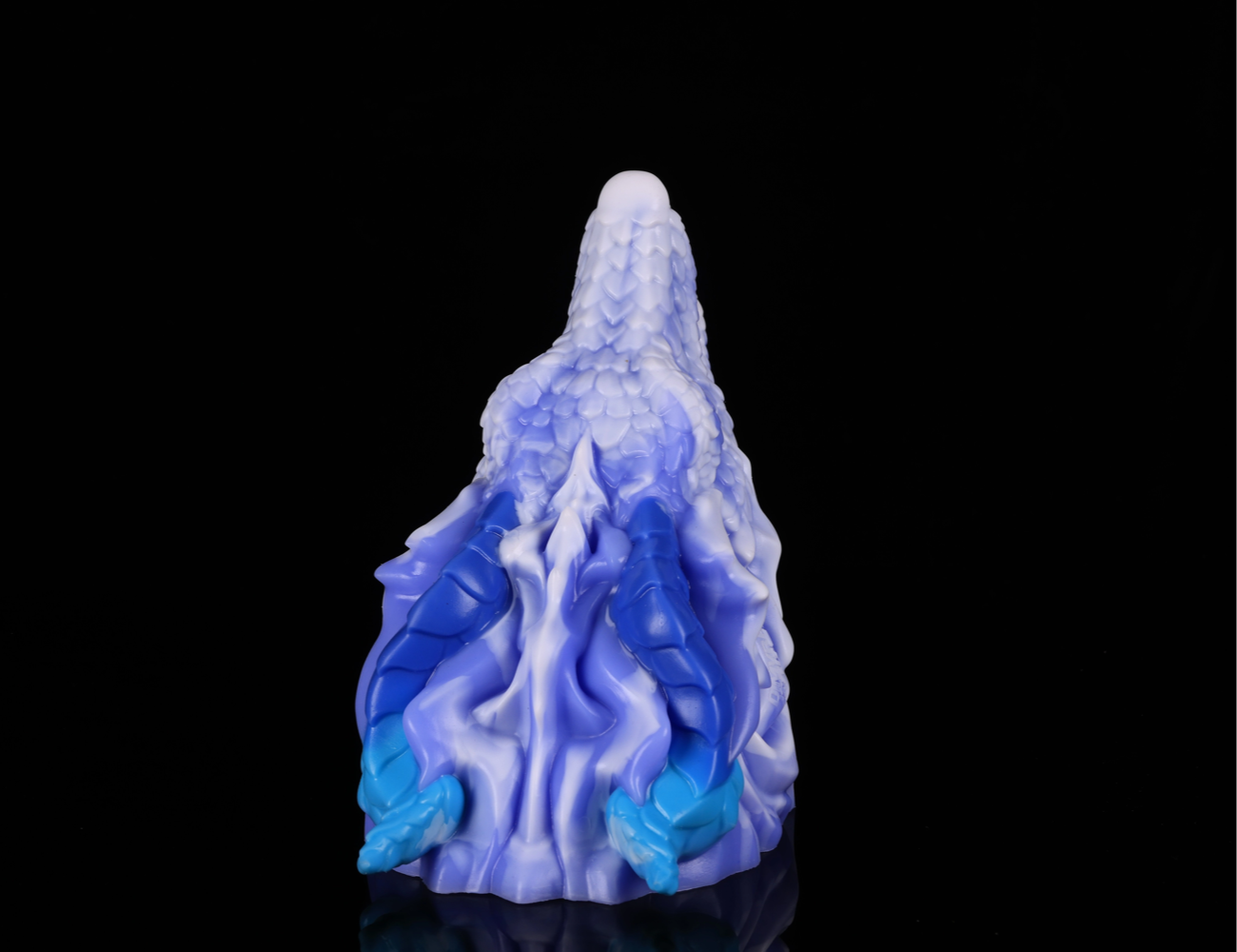 Intricate dorsal scales and blue horns on dimvra-figurine ice dragon statue.